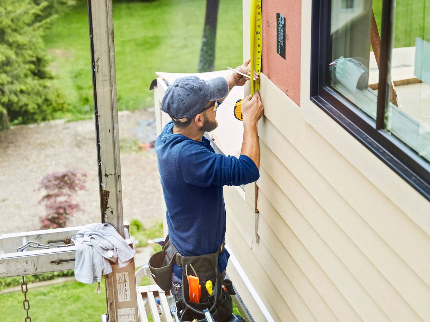 Expert craftsman from Charlotte Painting Pros performing detailed wood repair on a Charlotte, NC home