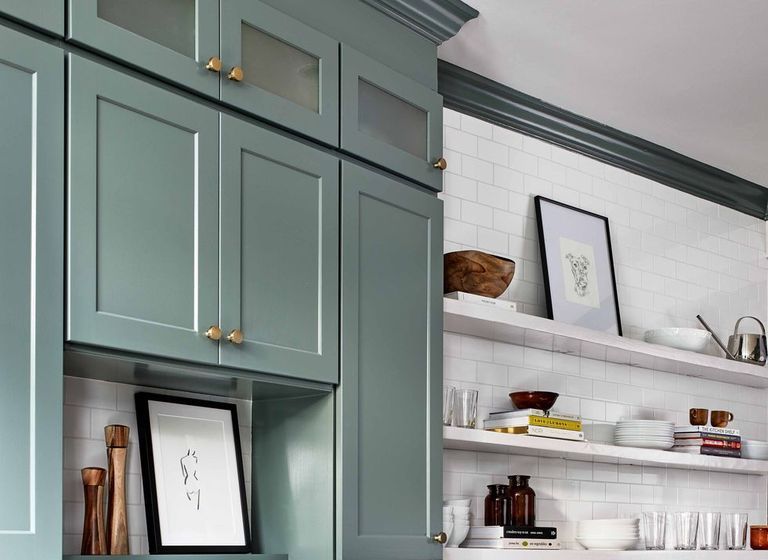 Experienced painter carefully masking and prepping cabinet doors for painting in a Cramerton, NC kitchen