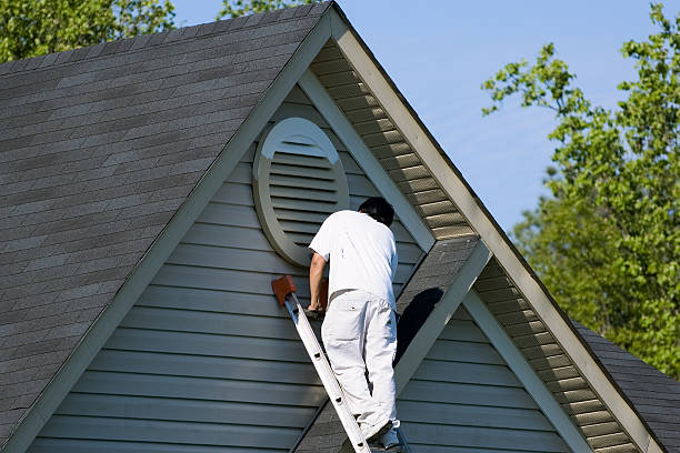 Painting crew preparing exterior walls for painting with safety gear and professional tools in Huntersville, NC