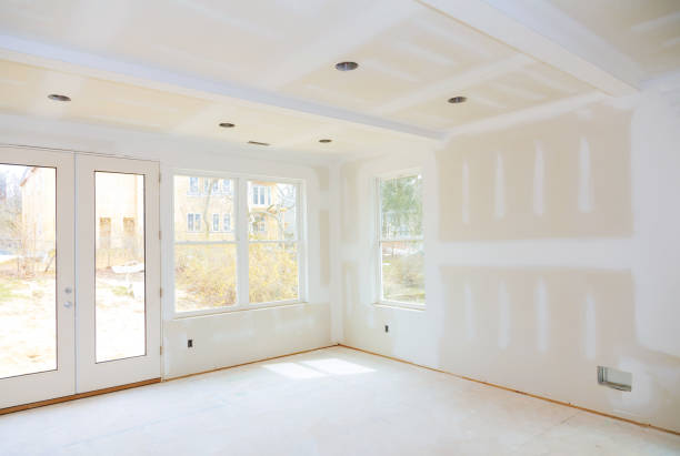 Specialist completing drywall repairs on a ceiling seam inside a Cornelius, NC home