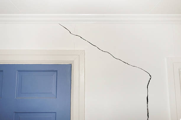 Drywall Repairs in McAdenville, NC underway as a technician smooths a patched bedroom wall